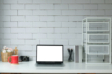 Modern workspace with computer with blank screen and equipment on white table.Blank screen for your information.