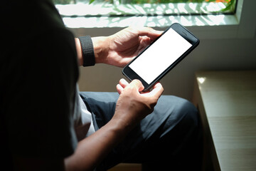 Close up view of business holding mobile phone with blank screen..