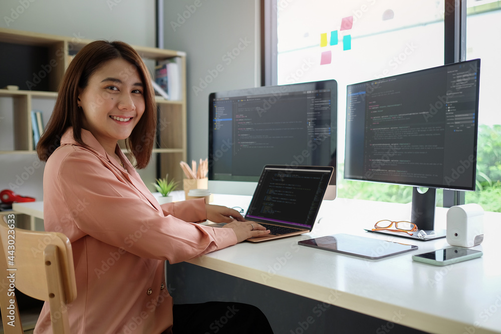 Aufkleber young female programmer working on project in modern office and smiling to camera.