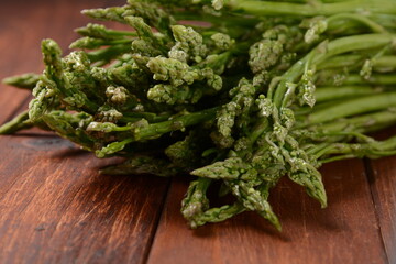 Asparagus. Fresh green asparagus on wooden table background. Bunch of fresh ripe green asparagus organic vegetables ready to cook or grill