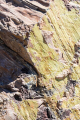 A fragment of a rocky relief made of mountain shales. Natural texture and stone background.