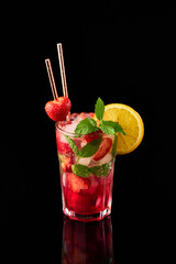 Strawberry mojito with lemon and mint isolated on black background with reflection
