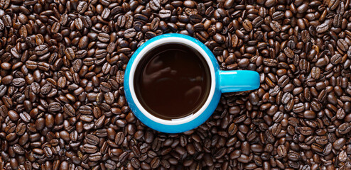 Cup of coffee and coffee beans. Top view, flat lay.