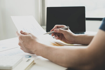 work from home, The hand of a man who works in finance sits at his desk at home and calculates financial graphs showing the results of his investments, planning the steps of his business growth