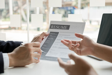 Business people hold a resume and talk to job applicants for job interviews about careers and Their personal history in the company. Recruitment concepts