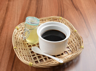 chilled black herbal jelly pudding (Gui ling gao) with fresh honey syrup dessert on wood table dessert halal menu