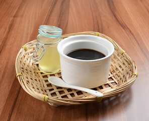 chilled black herbal jelly pudding (Gui ling gao) with fresh honey syrup dessert on wood table dessert halal menu