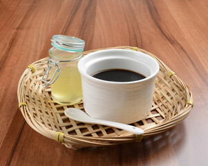 chilled black herbal jelly pudding (Gui ling gao) with fresh honey syrup dessert on wood table dessert halal menu