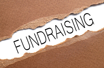 Fundraising. text on torn paper. test in black letters