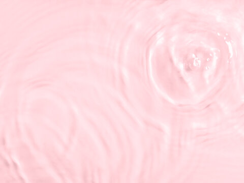 Pink water surface color background with ripples, circles and drops