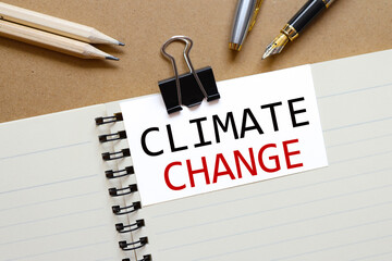 Climate Change. the inscription on the business card is attached to the notebook.