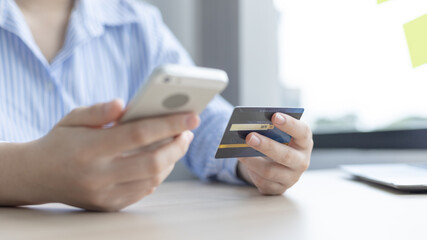 Women use smart phone to register online purchases using credit card payments, Technology for the use of smartphones for business or online financial transactions, Shopping online and banking online .