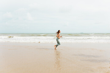 A caucasian woman runner in sportswear Outdoor jogging at the seaside.