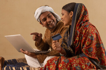 A RURAL COUPLE HAPPILY DOING ONLINE TRANSACTIONS TOGETHER