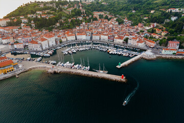 Fototapeta na wymiar Harbor of Piran city Slovenia. most beautiful city in Slovenian adriatic sea. Historical old town big bay and harbor for fishers and boat owners