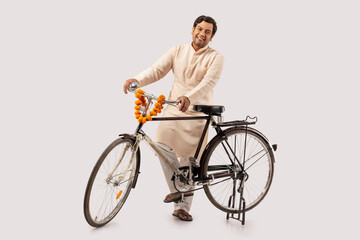 A RURAL MAN POSING HAPPILY WHILE HOLDING NEW BICYCLE