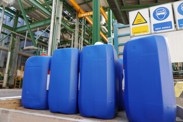 Blue plastic barrels on pallet in a chemical plant