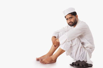 A COMMON MAN SITTING AND LOOKING AT CAMERA