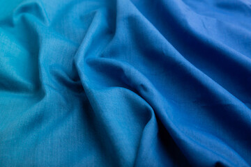 Fragment of cotton blue tissue. Side view, natural textile background.