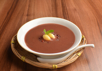 
hot cook red bean paste sweet dessert in bamboo basket on wood table asian dessert halal menu