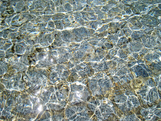 Surface of the water with glittering reflection of light 