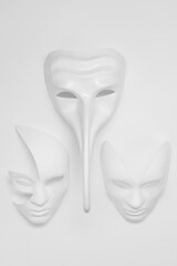 White venetian or theatrical masks of different shapes and types on a background