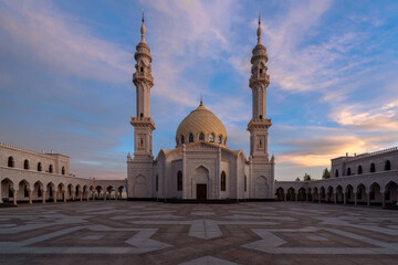 Obraz premium View of the White Mosque of the ancient city of Bolgar against the background of the sunset sky in the rays of the setting sun. Bolgar, Republic of Tatarstan, Russia