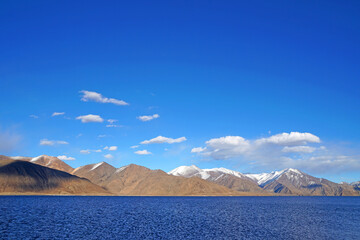 Landscape Lake Nature Scene of Pangong tso or Pangong Lake with Snow mountain background is best famous destination at Leh Ladakh ,Jammu and Kashmir , India - Blue nature travel  Background - travel - obrazy, fototapety, plakaty