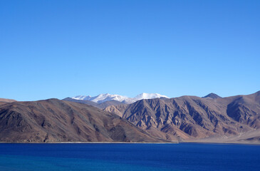Landscape  Nature Scene of Pangong tso or Pangong Lake with himalaya snow mountain background is best famous destination at Leh Ladakh ,Jammu and Kashmir , India                              
