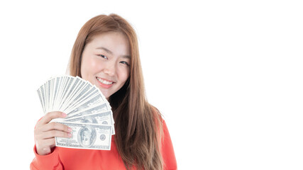 Successful beautiful Asian business young woman holding money US dollar bills in hand on white background , business concept