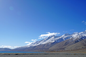 Landscape Nature Scene of Pangong tso or Pangong blue Lake with Snow mountain background at Leh Ladakh ,Jammu and Kashmir , India                                