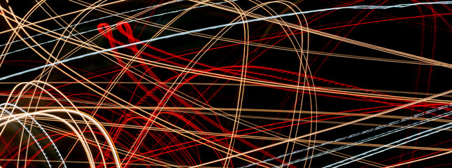 colored lines of lights on a black background
