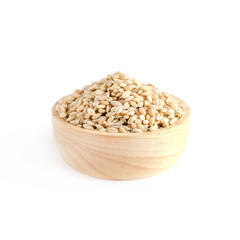 Dry organic brown barley seed pile in wooden bowl on white background. Concept of healthy and carbohydrate food type or agricultural product concept