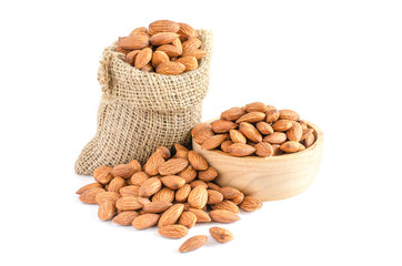 Group of organic almond seed pile in sack bag and wooden bowl on white background