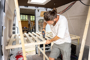 Man working on the interior of a camper van