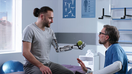 Doctor teaching patient to use prosthetic arm