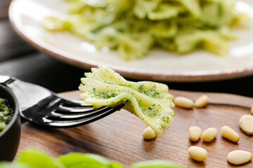 Eating of tasty pesto pasta, closeup