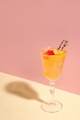 Glass of tasty grapefruit cocktail on color background, closeup