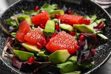 Tasty grapefruit salad on plate, closeup