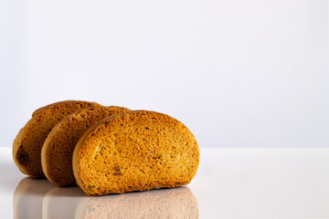 Three sweet fried croutons with raisins on a light background