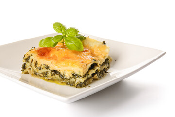 Plate with tasty green lasagna on white background