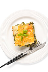 Plate with tasty green lasagna on white background