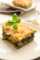 Plate with tasty green lasagna on table, closeup