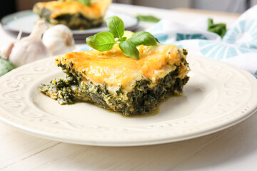 Plate with tasty green lasagna on table, closeup