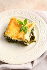 Plate with tasty green lasagna on table