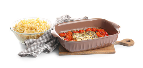 Baking dish with roasted tomatoes, feta cheese and pasta on white background