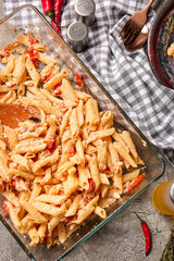 Baking dish with healthy pasta on grunge background
