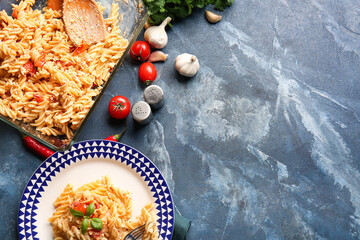 Healthy pasta with tomatoes and feta cheese on color background