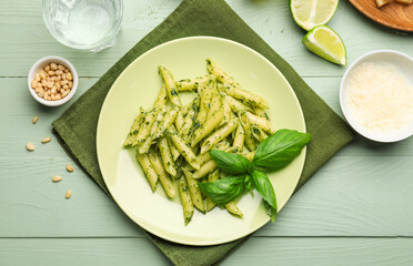 Plate with tasty pesto pasta on table
