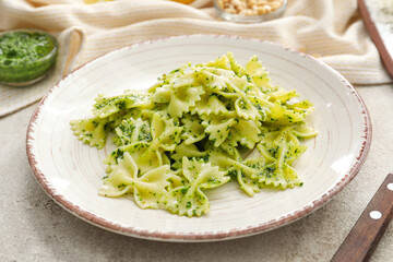 Plate with tasty pesto pasta on table
